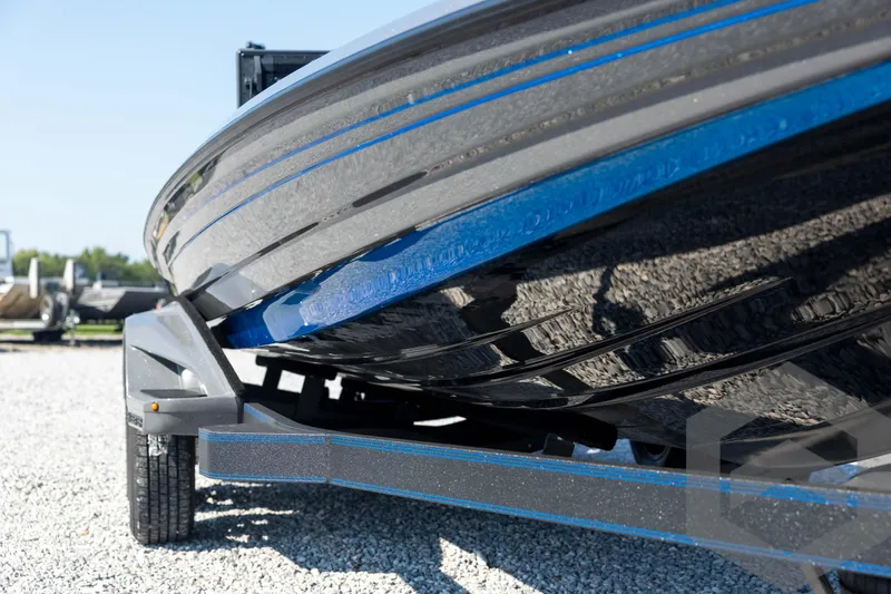 Slide: The Image of 2026 Skeeter FXR21 Apex boat on trailer, close-up view of hull and trailer details. - 12