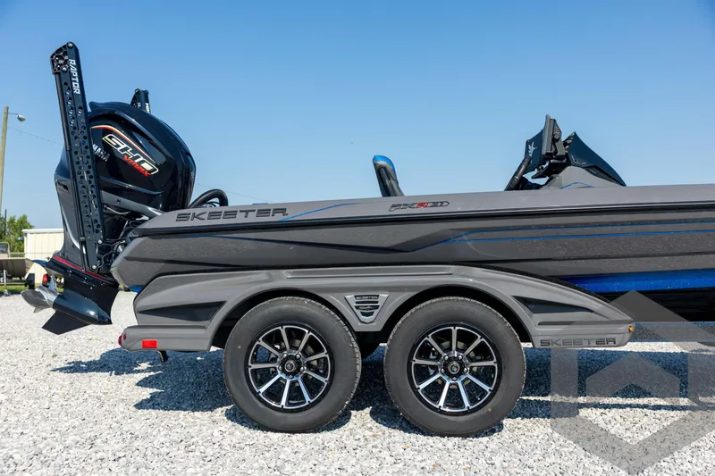 Slide: The Image of 2026 Skeeter FXR21 Apex boat on trailer, featuring sleek design and powerful engine. - 13