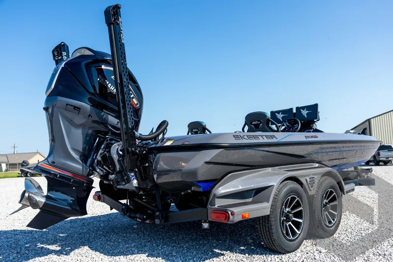 Slide: The Image of 2026 Skeeter FXR21 Apex boat with Yamaha engine on a trailer, parked on gravel. - 15