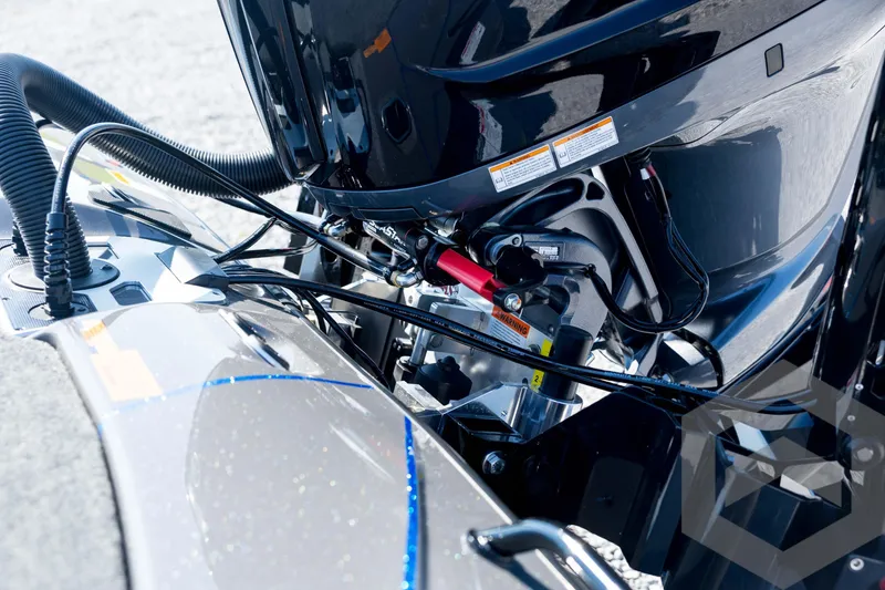 Slide: The Image of 2026 Skeeter FXR21 Apex boat engine close-up with cables and components. - 26