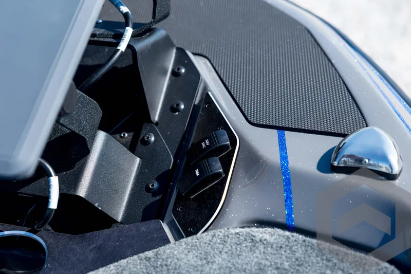 Slide: The Image of 2026 Skeeter FXR21 Apex boat dashboard with controls and blue accents. - 38