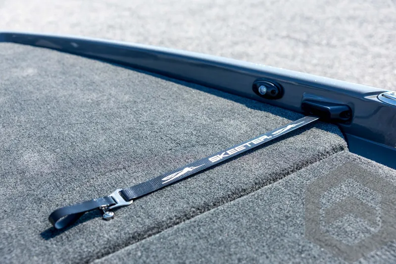 Slide: The Image of 2026 Skeeter FXR21 Apex boat deck with branded strap and carpeted surface. - 41