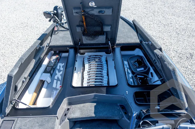 Slide: The Image of 2026 Skeeter FXR21 Apex boat storage compartments with organized fishing gear and equipment. - 46