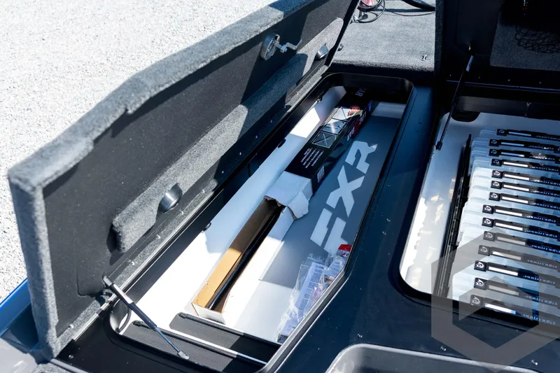 Slide: The Image of 2026 Skeeter FXR21 Apex boat storage compartment with organized fishing gear. - 47