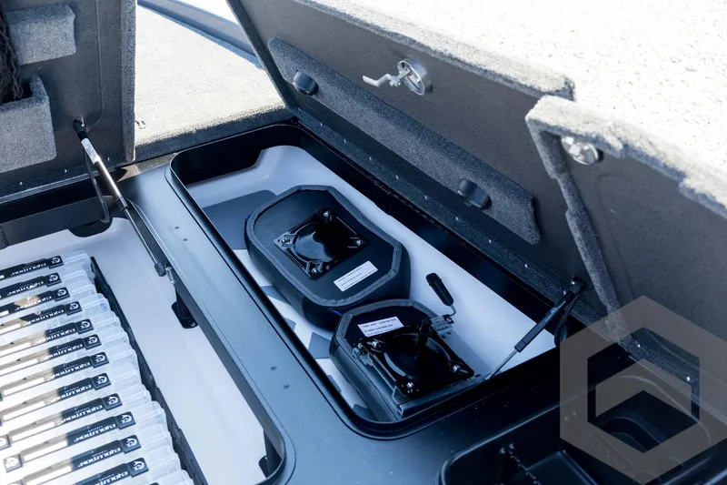 Slide: The Image of 2026 Skeeter FXR21 Apex storage compartment with organized fishing gear. - 49