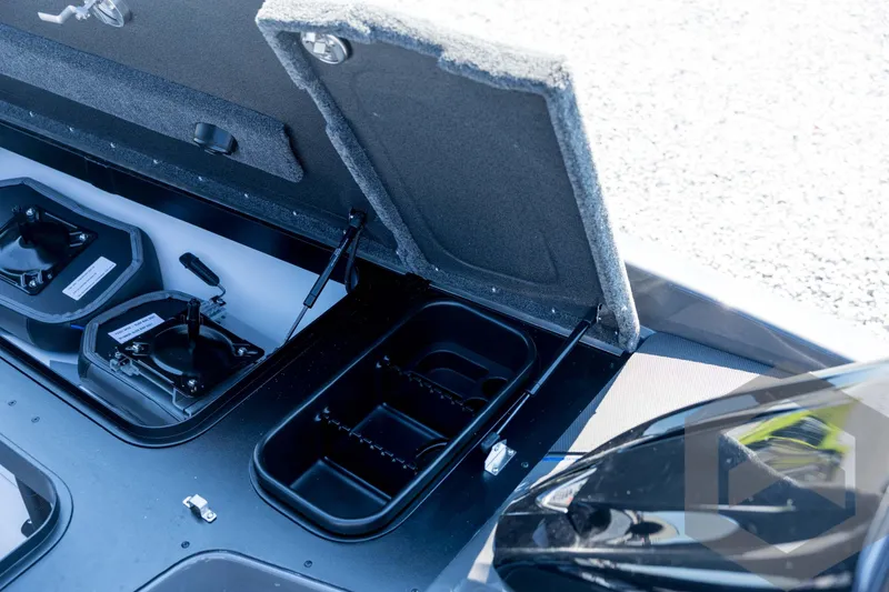 Slide: The Image of 2026 Skeeter FXR21 Apex boat storage compartment with open lid and organized interior. - 50