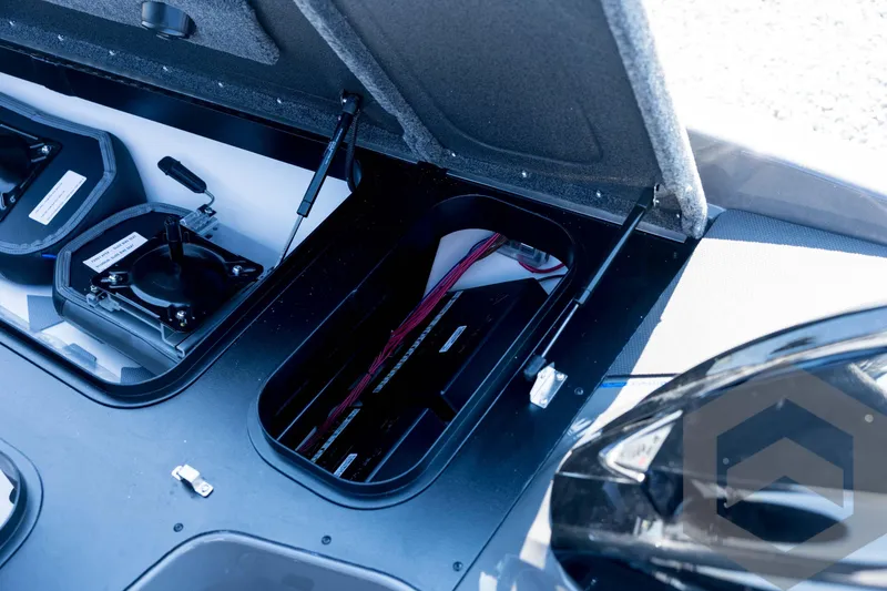 Slide: The Image of Open storage compartment in 2026 Skeeter FXR21 Apex boat, showcasing internal wiring and components. - 51