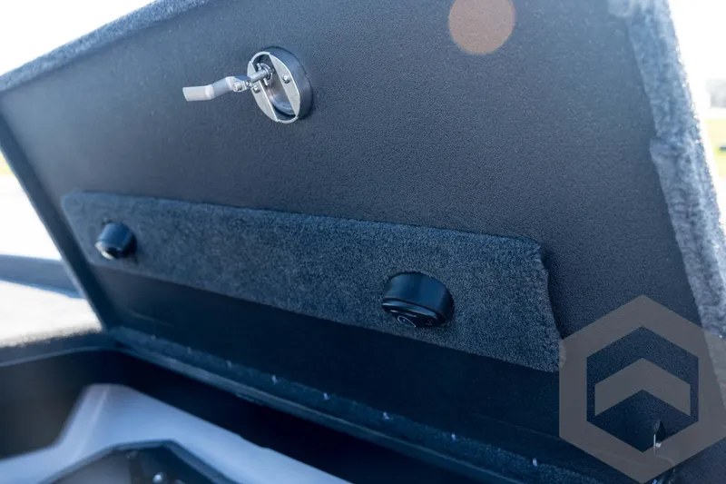Slide: The Image of 2026 Skeeter FXR21 Apex boat compartment with latch and padded interior. - 52