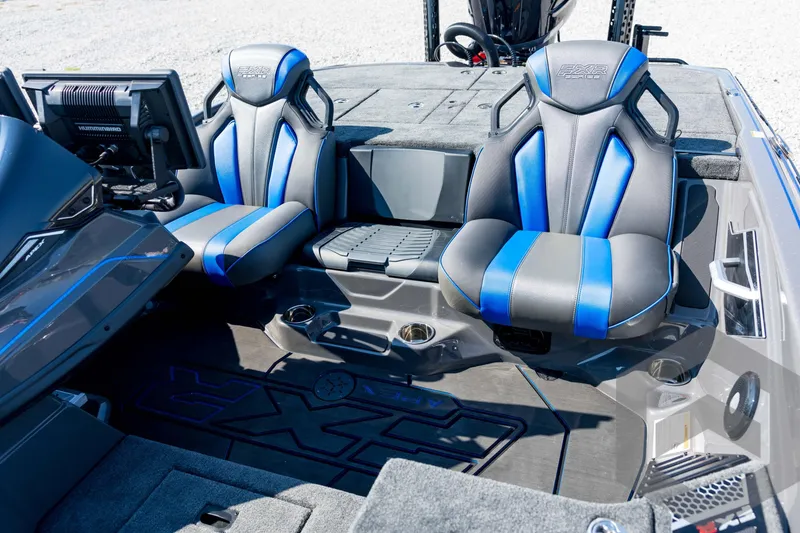 Slide: The Image of 2026 Skeeter FXR21 Apex boat interior with blue and gray seats, advanced dashboard. - 59