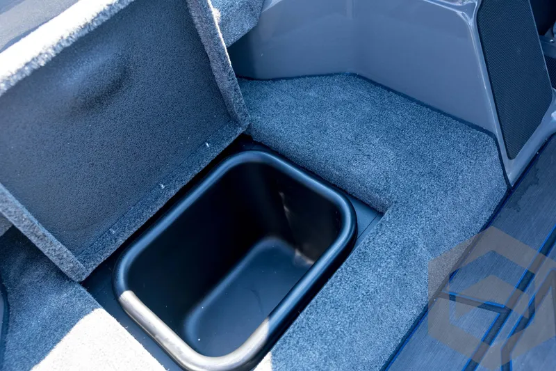 Slide: The Image of 2026 Skeeter FXR21 Apex boat storage compartment with carpeted interior. - 62