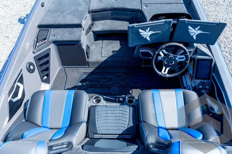 Slide: The Image of 2026 Skeeter FXR21 Apex boat interior with dual screens and blue-accented seats. - 63