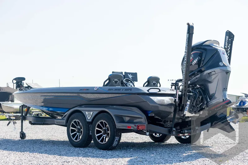 Slide: The Image of 2026 Skeeter FXR21 Apex boat on trailer, featuring sleek design and powerful engine. - 7