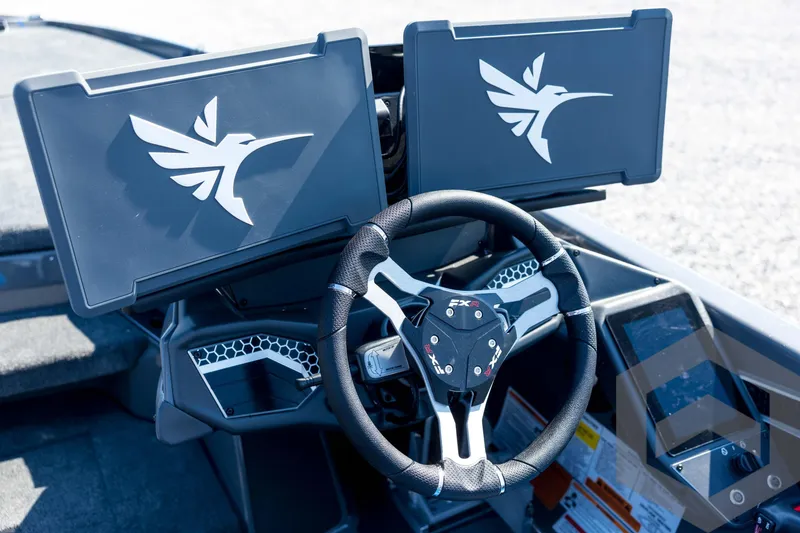 Slide: The Image of 2026 Skeeter FXR21 Apex boat dashboard with dual screens and steering wheel. - 70