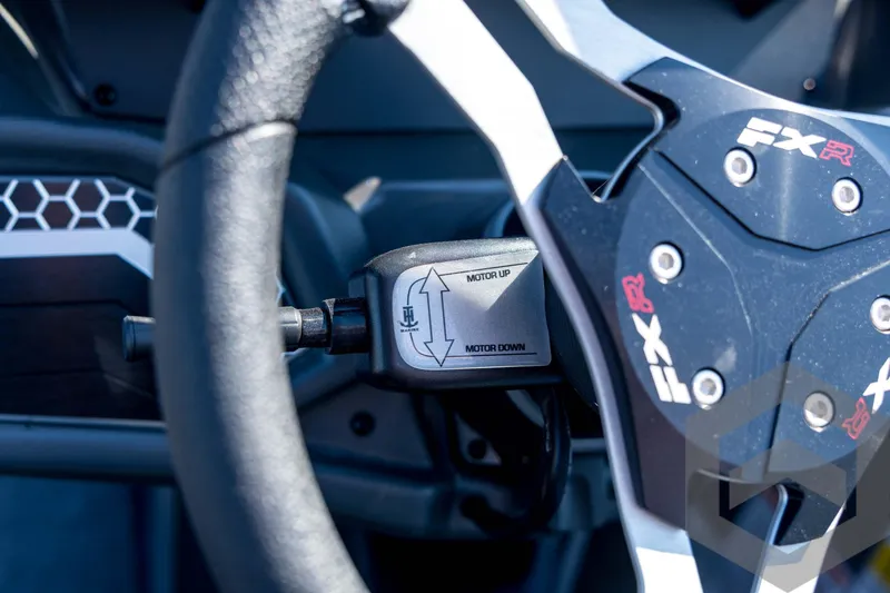 Slide: The Image of Steering wheel of 2026 Skeeter FXR21 Apex boat with motor control lever. - 72