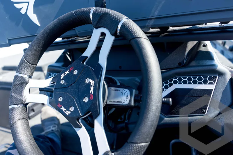 Slide: The Image of Steering wheel of 2026 Skeeter FXR21 Apex boat, featuring sleek design and controls. - 73