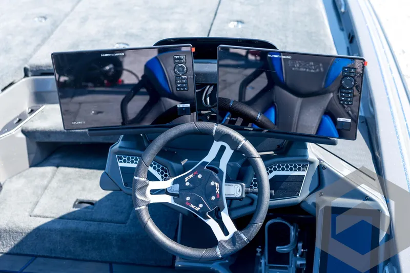 Slide: The Image of 2026 Skeeter FXR21 Apex boat dashboard with dual Humminbird displays and steering wheel. - 75