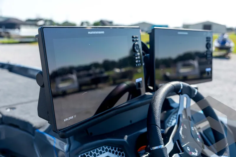 Slide: The Image of 2026 Skeeter FXR21 Apex boat dashboard with dual Humminbird Xplore 12 displays. - 76