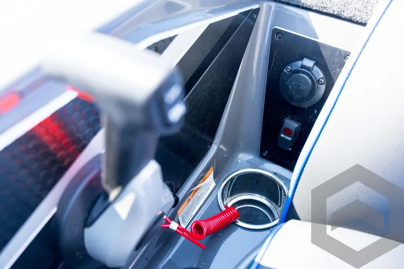 Slide: The Image of Interior of 2026 Skeeter FXR21 Apex boat, featuring control panel and cup holder. - 79