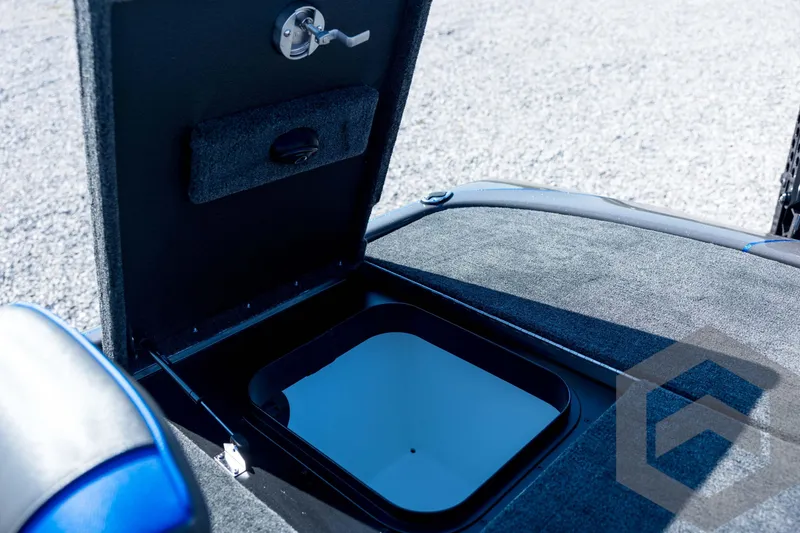 Slide: The Image of Open storage compartment on 2026 Skeeter FXR21 Apex boat, featuring carpeted interior. - 85
