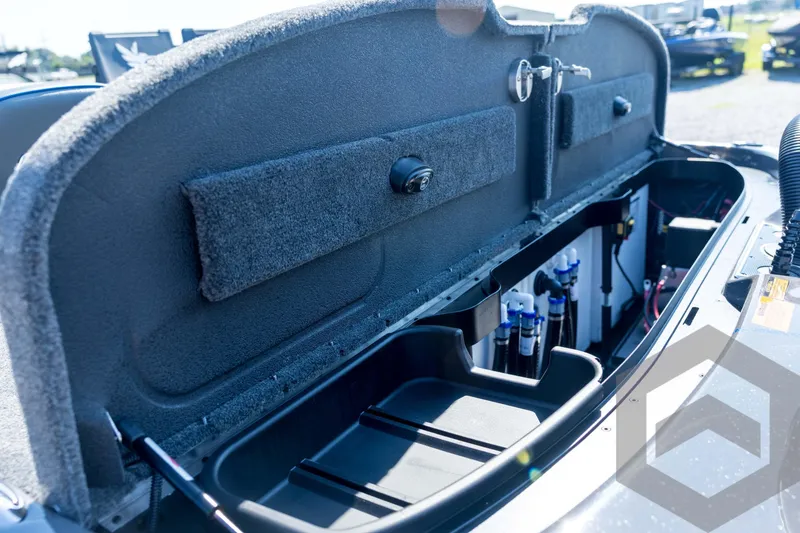 Slide: The Image of 2026 Skeeter FXR21 Apex boat storage compartment with organized interior and equipment. - 88