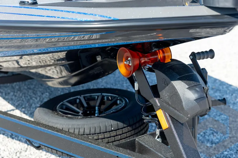 Slide: The Image of 2026 Skeeter FXR21 Apex boat trailer detail with winch and wheel. - 9