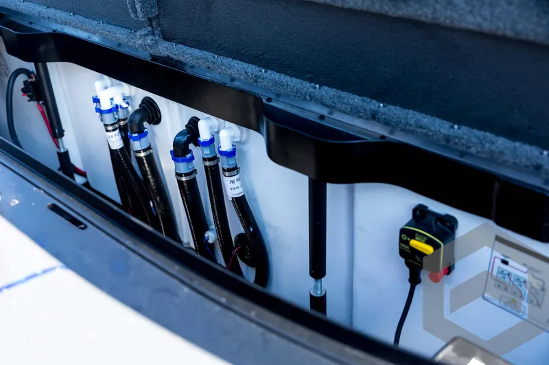 Slide: The Image of 2026 Skeeter FXR21 Apex boat compartment with plumbing and electrical components. - 91