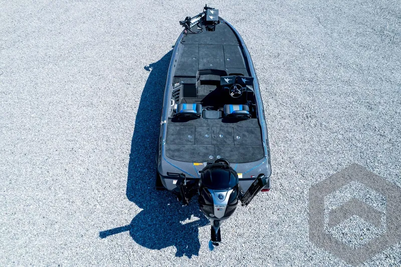 Slide: The Image of 2026 Skeeter FXR21 Apex boat, aerial view on gravel surface, showcasing sleek design and modern features. - 93