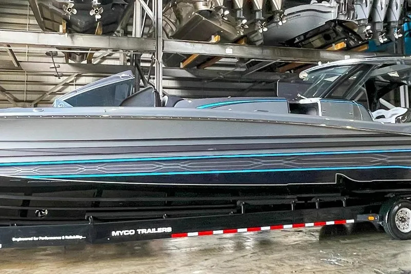 Slide: The Image of 2022 MTI V50 boat on trailer in storage facility. - 2