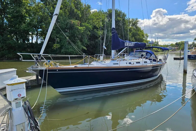 The Image of 1988 Tartan 40 sailboat docked in a serene marina setting. - 0