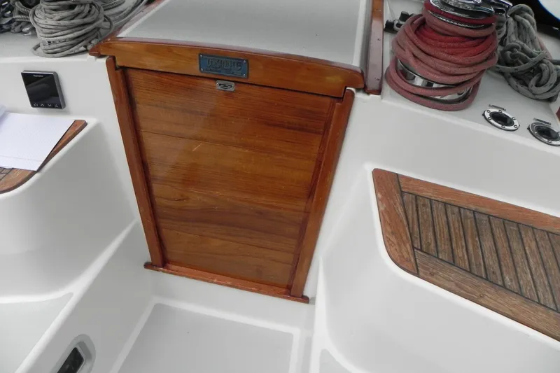 Slide: The Image of Cockpit of 1988 Tartan 40 sailboat with wooden hatch and coiled ropes. - 10