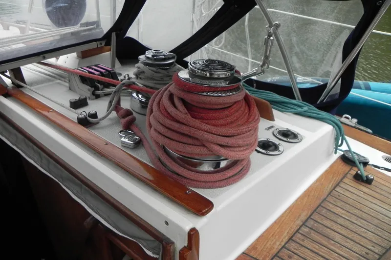 Slide: The Image of 1988 Tartan 40 sailboat cockpit with winch, ropes, and wooden deck details. - 13