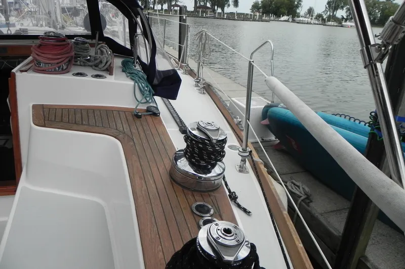 Slide: The Image of 1988 Tartan 40 sailboat deck with winches and ropes docked by the water. - 16