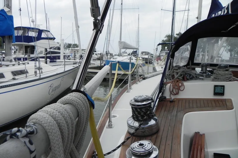 Slide: The Image of 1988 Tartan 40 sailboat docked in marina, surrounded by other boats. - 17