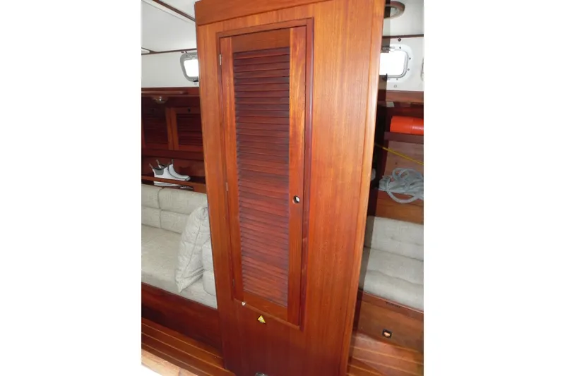 Slide: The Image of 1988 Tartan 40 yacht interior with wooden cabinetry and seating area. - 30