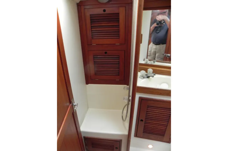 Slide: The Image of 1988 Tartan 40 yacht bathroom with wooden cabinets and a sink. - 32
