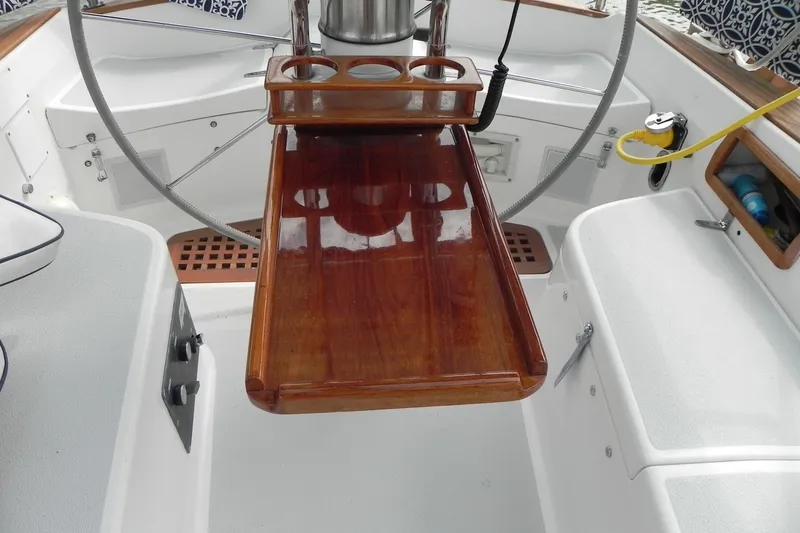 Slide: The Image of Cockpit of 1988 Tartan 40 sailboat with polished wooden table and steering wheel. - 34