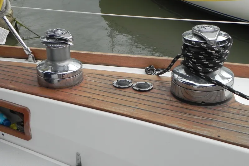 Slide: The Image of Deck of 1988 Tartan 40 sailboat with winches and rope, showcasing teak wood finish. - 7