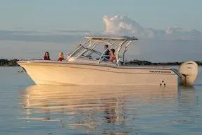 Slide: The Image of 2026 Grady-White Freedom 275 boat on calm water at sunset. - 12