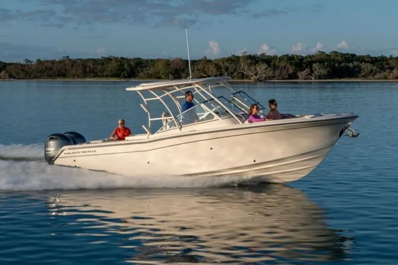The Image of 2026 Grady-White Freedom 275 boat cruising on calm water with passengers. - 4