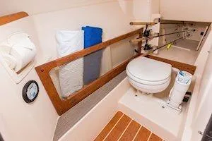Slide: The Image of 2026 Grady-White Freedom 275 boat interior with toilet and storage area. - 6