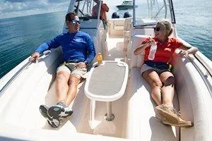 Slide: The Image of Couple relaxing on a 2026 Grady-White Freedom 275 boat, enjoying a sunny day at sea. - 8