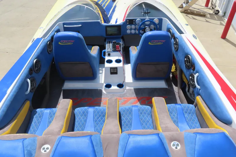 Slide: The Image of Interior of a 2003 Spectre 36 Cat boat with blue and yellow seating. - 13