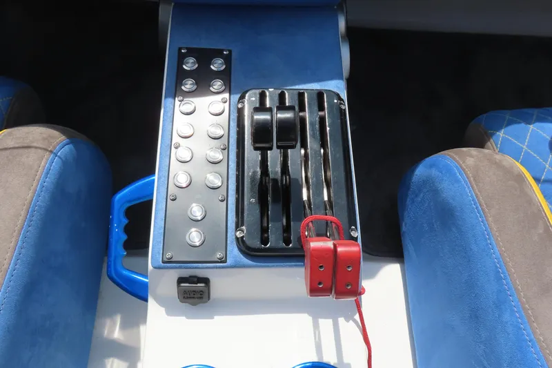 Slide: The Image of Center console of a 2003 Spectre 36 Cat boat with controls and switches. - 15