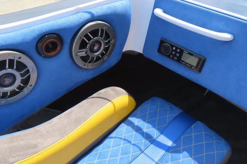 Slide: The Image of Interior of 2003 Spectre 36 Cat with blue upholstery, speakers, and audio controls. - 16