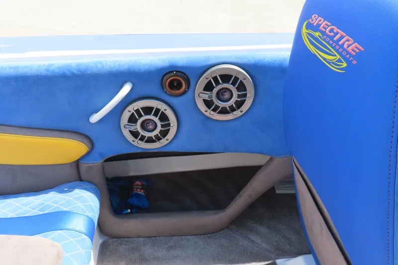 Slide: The Image of Interior of 2003 Spectre 36 Cat powerboat with blue and yellow seating, featuring speakers. - 17