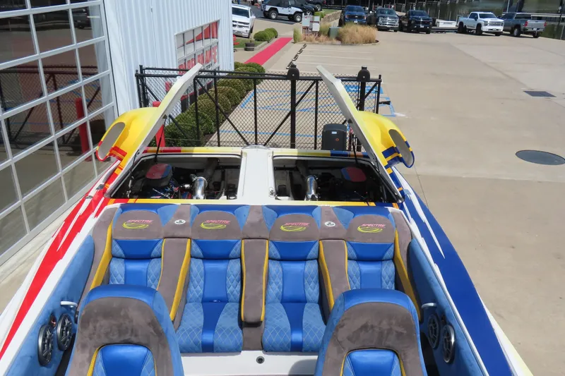 Slide: The Image of 2003 Spectre 36 Cat boat with vibrant seating and open engine compartment. - 18