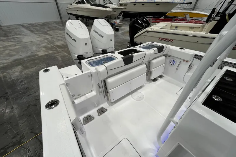 Slide: The Image of 2026 Wellcraft 302 Fisherman boat interior with dual Mercury engines in a showroom. - 10