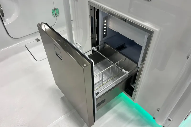 Slide: The Image of 2026 Wellcraft 302 Fisherman boat with open stainless steel drawer refrigerator. - 12