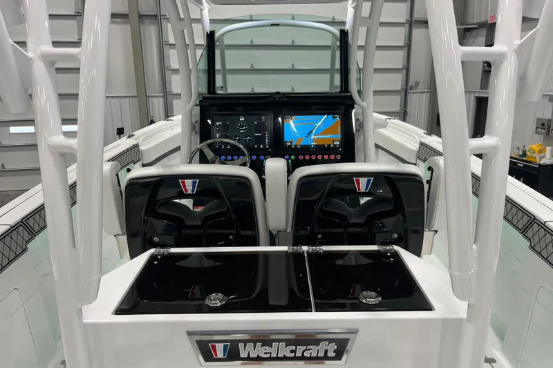 Slide: The Image of 2026 Wellcraft 302 Fisherman boat cockpit with advanced navigation displays. - 13