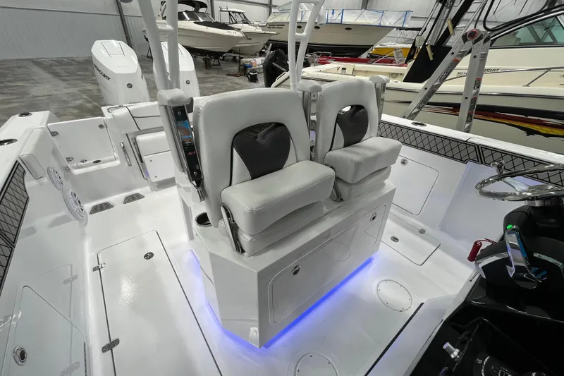 Slide: The Image of 2026 Wellcraft 302 Fisherman boat interior with modern seating and illuminated deck. - 14